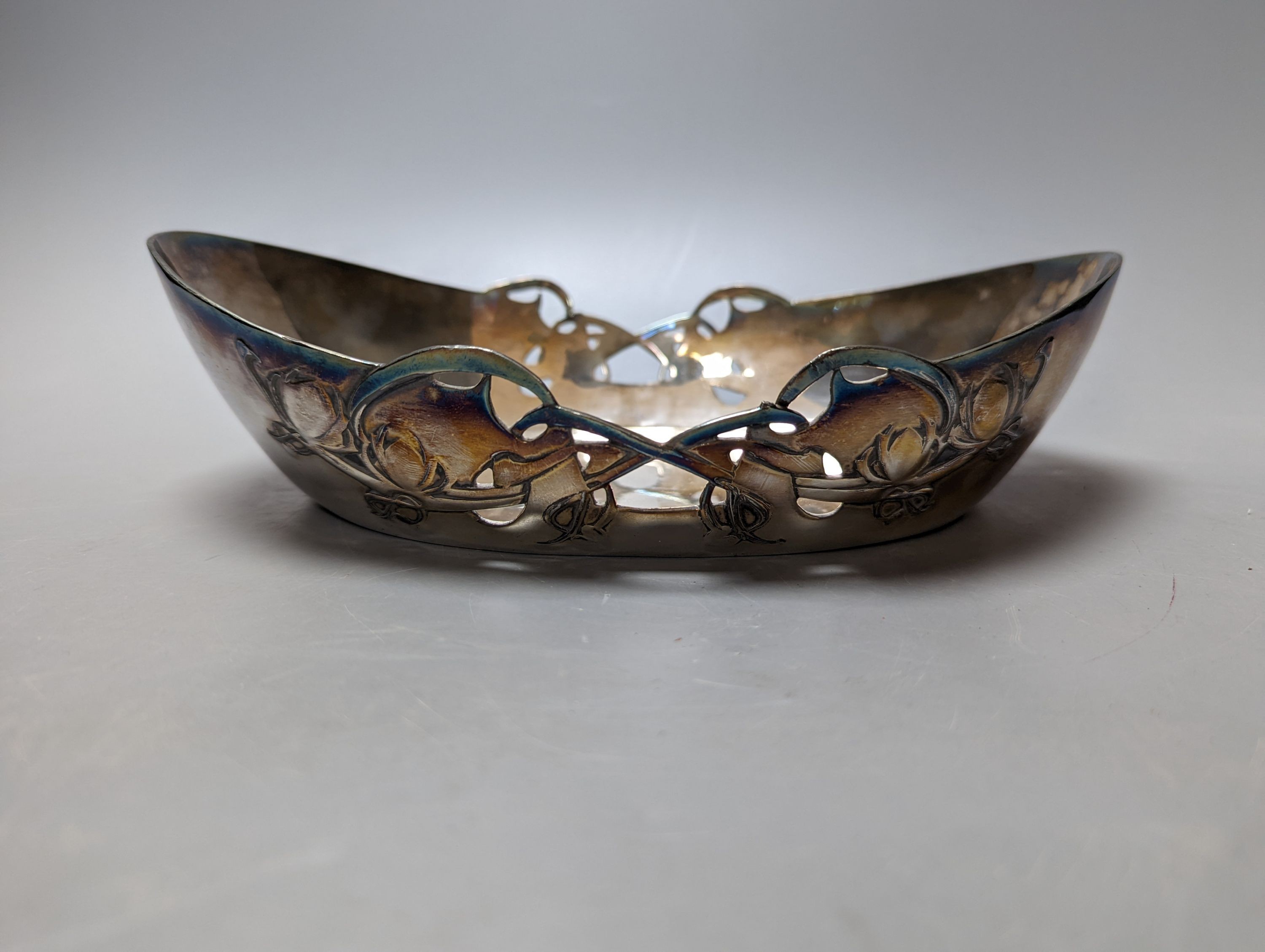 A Tudric pewter oval bowl, model no. 0535, 25cm long and an Arts & Crafts style plated pedestal bowl, 21.5cm diameter